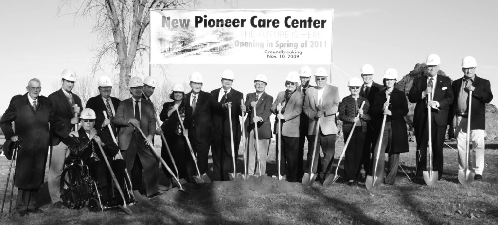 people in a line with shovels for groundbreaking