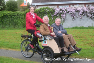 hree people riding a trishaw in Ireland