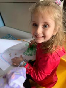 Child preparing art for residents