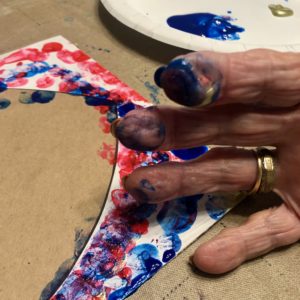 Picture of a resident's fingers with paint on them